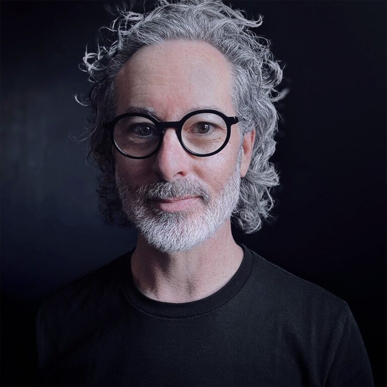 hairdresser Tom Zappala sitting in his Melbourne curly hair salon.